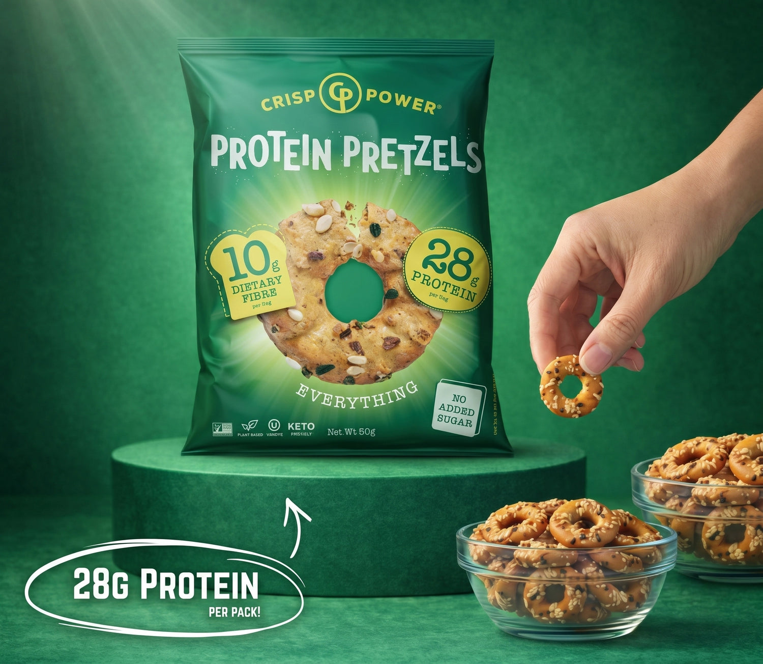 Protein pretzels everything flavour packaging with a hand holding a pretzel, on a green background